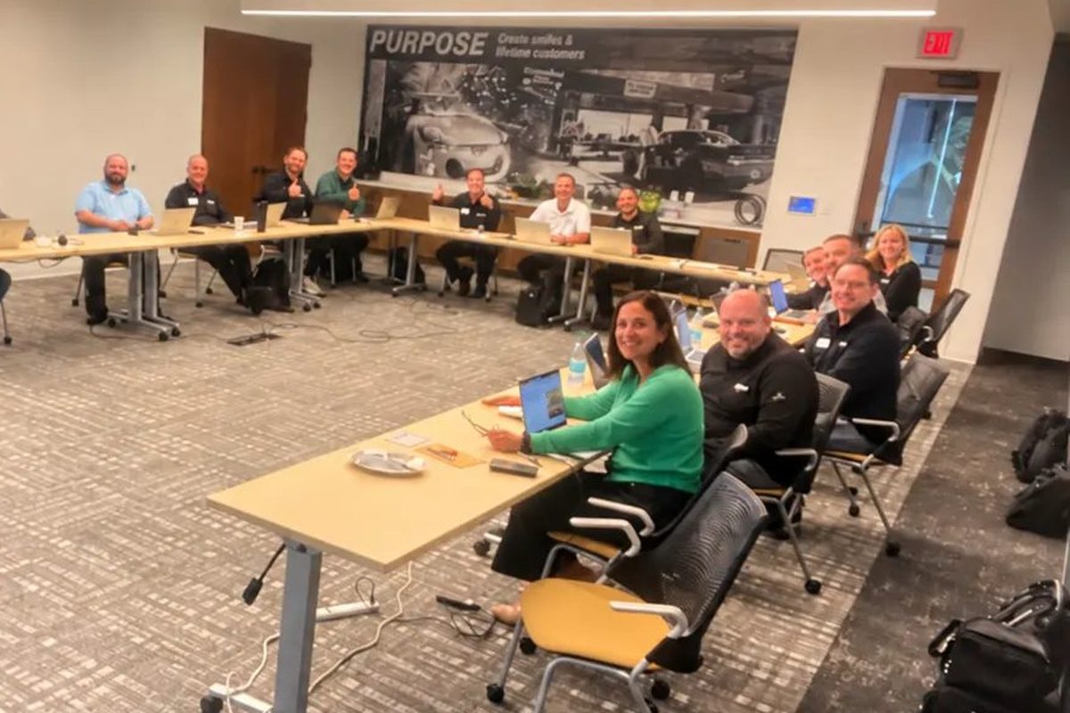 The Crew Carwash team at laptops in their training room